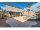 Backyard featuring a pool, spa, covered patio, and lush landscaping at 823 Safflower Ct, Henderson, NV 89015
