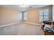 A roomy bedroom featuring neutral carpet, plantation shutters, and warm, neutral walls at 823 Safflower Ct, Henderson, NV 89015