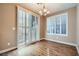 Dining area featuring modern lighting, wood flooring, and natural light at 823 Safflower Ct, Henderson, NV 89015