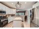 Modern kitchen with stainless steel appliances, granite countertops and white cabinets at 823 Safflower Ct, Henderson, NV 89015