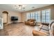 Spacious living room with wood floors, neutral paint and lots of windows that look out to the backyard at 823 Safflower Ct, Henderson, NV 89015