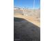 View of dirt backyard enclosed with block fencing, ready for landscaping at 8408 W Gilmore Ave, Las Vegas, NV 89129