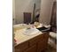 Bathroom with large mirror, oak cabinets and ample counter space at 8408 W Gilmore Ave, Las Vegas, NV 89129