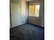 Bedroom with sliding closet doors and a window overlooking outside at 8408 W Gilmore Ave, Las Vegas, NV 89129