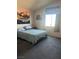 Bedroom featuring soft carpet, natural light from window, and modern decor at 8408 W Gilmore Ave, Las Vegas, NV 89129