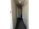 Hallway with storage closets and neutral colored carpet at 8408 W Gilmore Ave, Las Vegas, NV 89129