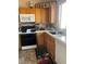 Functional kitchen with oak cabinetry, and modern appliances at 8408 W Gilmore Ave, Las Vegas, NV 89129