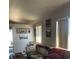Cozy living room with neutral tones, bright windows, and comfortable seating area at 8408 W Gilmore Ave, Las Vegas, NV 89129