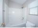 Bright, tiled shower and bathtub combo in a clean, well-lit bathroom at 8628 Tomnitz Ave # 101, Las Vegas, NV 89178