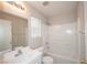 Bright bathroom featuring a single sink vanity with a large mirror and an adjoining bath and shower at 8628 Tomnitz Ave # 101, Las Vegas, NV 89178