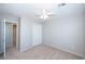 A bright bedroom with plush carpet, a ceiling fan, and a large closet space for ample storage at 8628 Tomnitz Ave # 101, Las Vegas, NV 89178