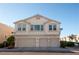 Three car garage exterior view of condo, each with its own entrance and front window at 8628 Tomnitz Ave # 101, Las Vegas, NV 89178