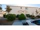 Exterior of condo showing front door entrances, sidewalks and green bushes at 8628 Tomnitz Ave # 101, Las Vegas, NV 89178
