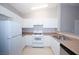 Bright kitchen featuring white cabinets, white refrigerator and light granite counter tops at 8628 Tomnitz Ave # 101, Las Vegas, NV 89178