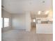 Open floor plan of living room leading into the kitchen with white cabinets at 8628 Tomnitz Ave # 101, Las Vegas, NV 89178