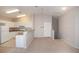 Living room next to kitchen with white cabinets, white refrigerator and light counter tops at 8628 Tomnitz Ave # 101, Las Vegas, NV 89178