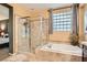 Clean bathroom featuring a walk-in shower and separate soaking tub at 9262 Edgeworth Pl, Las Vegas, NV 89123