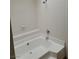 Bright bathroom showing a white bathtub with white tile surround and a shower head at 9325 W Desert Inn Rd # 233, Las Vegas, NV 89117