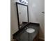 Bathroom features a granite countertop vanity with a framed mirror and new light fixture at 9325 W Desert Inn Rd # 233, Las Vegas, NV 89117