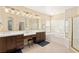 Bright bathroom boasts double sinks, vanity area, soaking tub, and shower at 9517 Spanish Steps Ln, Las Vegas, NV 89117