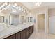 Spacious bathroom with dual sinks, a large mirror, and plenty of lighting at 9517 Spanish Steps Ln, Las Vegas, NV 89117
