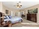 Cozy bedroom with a ceiling fan, dresser, and comfortable bed, leading to other rooms at 9517 Spanish Steps Ln, Las Vegas, NV 89117