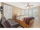 Bright bedroom with a modern ceiling fan and access to the backyard at 9517 Spanish Steps Ln, Las Vegas, NV 89117