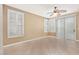 Empty bedroom filled with neutral tones, tile flooring, and a sliding glass door at 9517 Spanish Steps Ln, Las Vegas, NV 89117