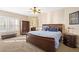 Spacious bedroom featuring natural light, carpet floors, fan, and wooden furniture at 9517 Spanish Steps Ln, Las Vegas, NV 89117