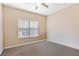 Neutral bedroom with a window, plush carpeting, and ample space for furniture arrangements at 9517 Spanish Steps Ln, Las Vegas, NV 89117