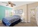 Bright bedroom featuring shuttered windows, floral bedding, and a ceiling fan for added comfort at 9517 Spanish Steps Ln, Las Vegas, NV 89117