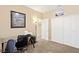 Comfortable bedroom with an office setup, neutral walls and carpet, plus closet space at 9517 Spanish Steps Ln, Las Vegas, NV 89117