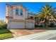 Elegant home with a three-car garage, landscaped lawn, and lush palm trees at 9517 Spanish Steps Ln, Las Vegas, NV 89117