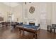 Game room with a pool table, fireplace, and hardwood floors at 9517 Spanish Steps Ln, Las Vegas, NV 89117