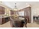 Well-equipped kitchen boasts dark wood cabinetry, granite countertops, and stainless-steel appliances at 9517 Spanish Steps Ln, Las Vegas, NV 89117