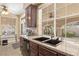 Kitchen features a double sink, granite countertops, stainless appliances and backyard views at 9517 Spanish Steps Ln, Las Vegas, NV 89117