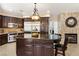 Beautiful kitchen with a large center island, dark cabinets, and stainless steel appliances at 9517 Spanish Steps Ln, Las Vegas, NV 89117