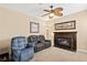 Cozy living room features a fireplace, ceiling fan, and comfortable seating at 9517 Spanish Steps Ln, Las Vegas, NV 89117