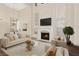Bright living room features a fireplace, hardwood floors, and an abundance of natural light at 9517 Spanish Steps Ln, Las Vegas, NV 89117