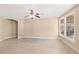 Spacious living room features tile flooring, neutral paint, arched doorways, and multiple windows at 9517 Spanish Steps Ln, Las Vegas, NV 89117