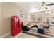 Spacious living room features comfortable seating, a vintage Coca-Cola vending machine, and a ceiling fan at 9517 Spanish Steps Ln, Las Vegas, NV 89117