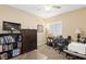 Well-lit home office with built-in bookshelves, a desk, and comfortable seating at 9517 Spanish Steps Ln, Las Vegas, NV 89117