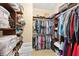 Walk-in closet offers ample storage with shelves, hanging rods, and bins at 9517 Spanish Steps Ln, Las Vegas, NV 89117