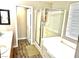 Bright bathroom featuring a shower over the bathtub, glass enclosure, and updated fixtures at 981 Leadville Meadows Dr, Henderson, NV 89052