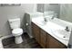 Bathroom with a double sink vanity offering wood cabinets, white countertops, and modern fixtures at 981 Leadville Meadows Dr, Henderson, NV 89052