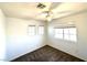 Comfortable carpeted bedroom boasts a ceiling fan and windows for ample lighting at 981 Leadville Meadows Dr, Henderson, NV 89052