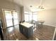 Eat-in kitchen with gray island, table, ceiling fan, and access to the backyard at 981 Leadville Meadows Dr, Henderson, NV 89052