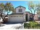 Charming two-story home featuring a well-manicured lawn and a spacious two-car garage at 981 Leadville Meadows Dr, Henderson, NV 89052