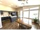 Bright, open kitchen with dark cabinets, island, and hardwood floors at 981 Leadville Meadows Dr, Henderson, NV 89052