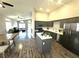 Spacious kitchen with gray cabinets, stainless steel appliances, and center island open to living area at 981 Leadville Meadows Dr, Henderson, NV 89052